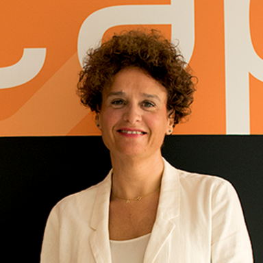 Retrato de una mujer con cabello rizado en un fondo de colores naranja y negro, vestida con una chaqueta blanca.