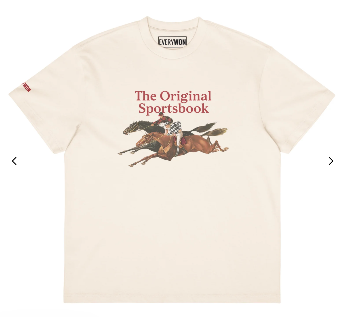 Cream-colored T-shirt with a graphic of a horse race and a jockey, and the text "The Original Sportsbook" in red.