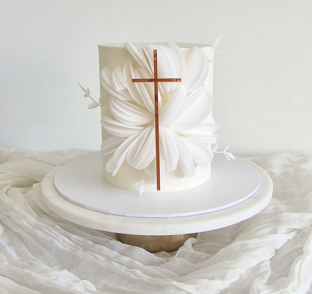 Elegant white christening cake with rice paper decor and acrylic gold cross