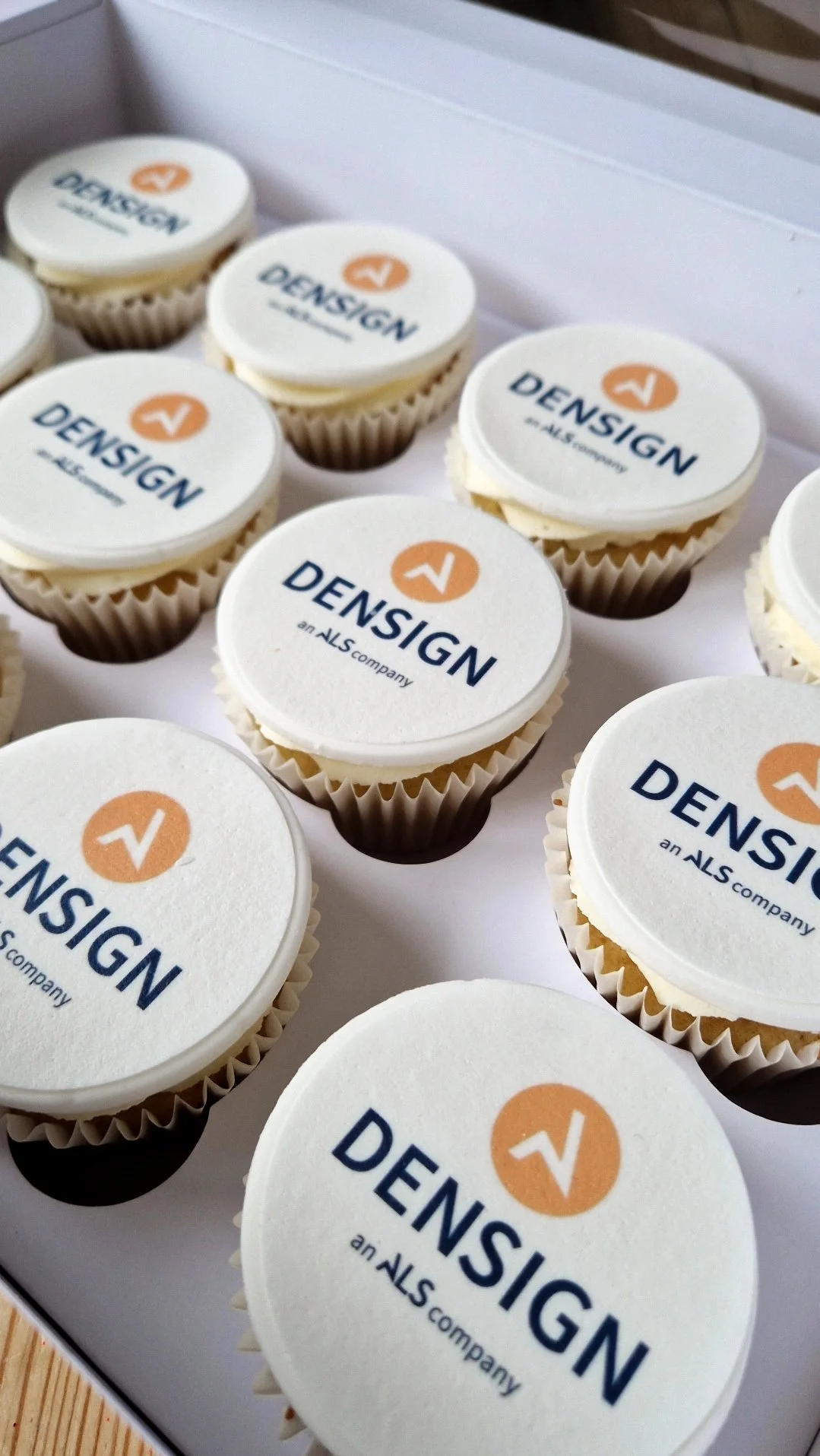 Branded cupcakes with edible logo toppers for corporate events and business celebrations
