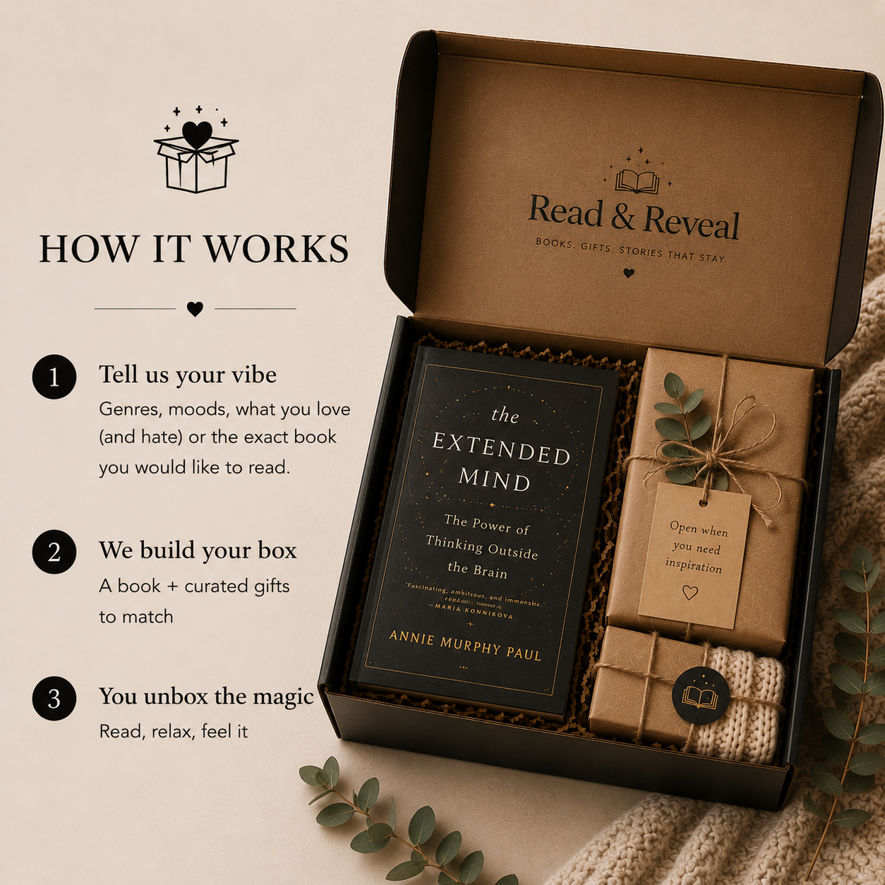A Read & Reveal gift box open to show a book titled "The Extended Mind" by Annie Murphy Paul and two wrapped gifts, one with a leaf and thankful tag, on a soft beige background with eucalyptus leaves and a knitted blanket. To the left, instructions explain how the system works, including telling your vibe, the building of your box, and unboxing the magic.