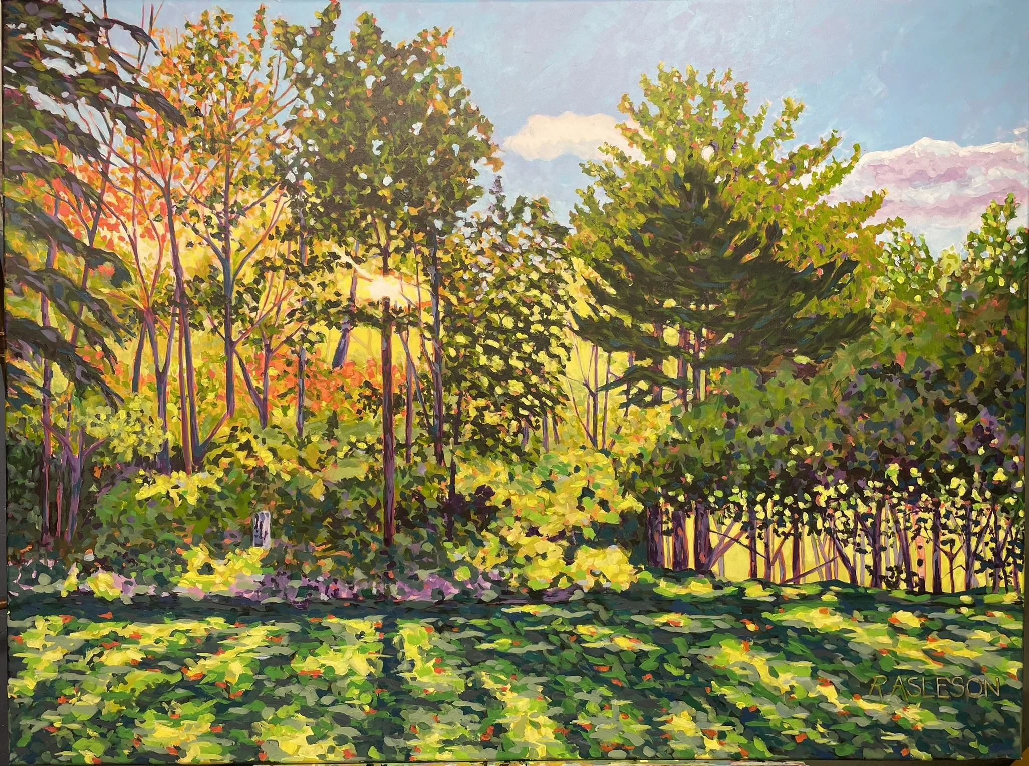 Sun streams through impressionistic painting. Deep blue green shadows strech along foreground, and trees glow with sunlight.
