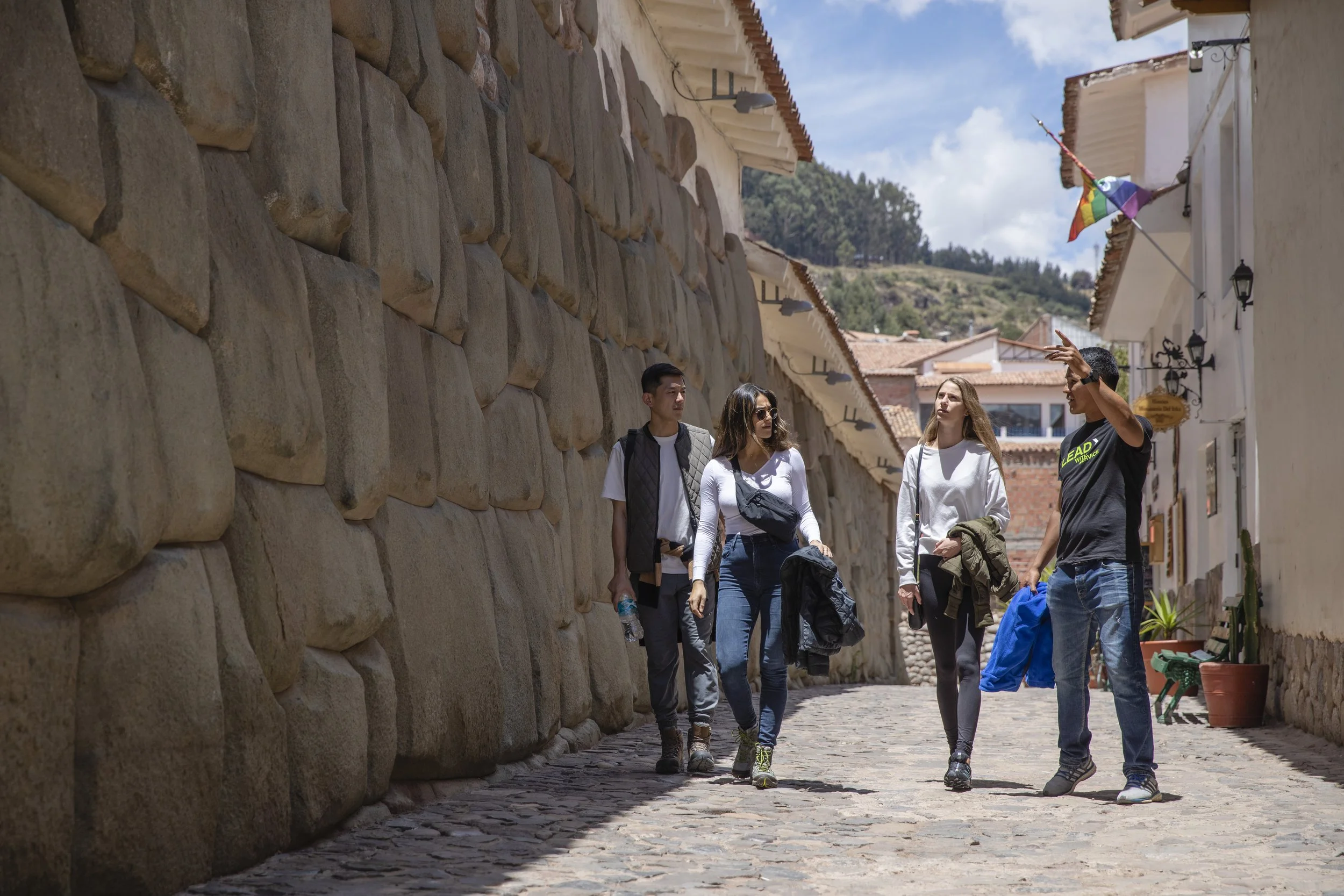 Peru Cusco Inca Stone Wall Travellers CEO Walking.jpg