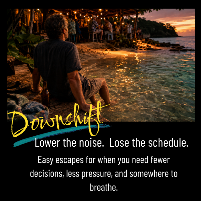 A man sitting by the water at sunset, with a beach bar and other people in the background, promoting mindfulness and relaxation.