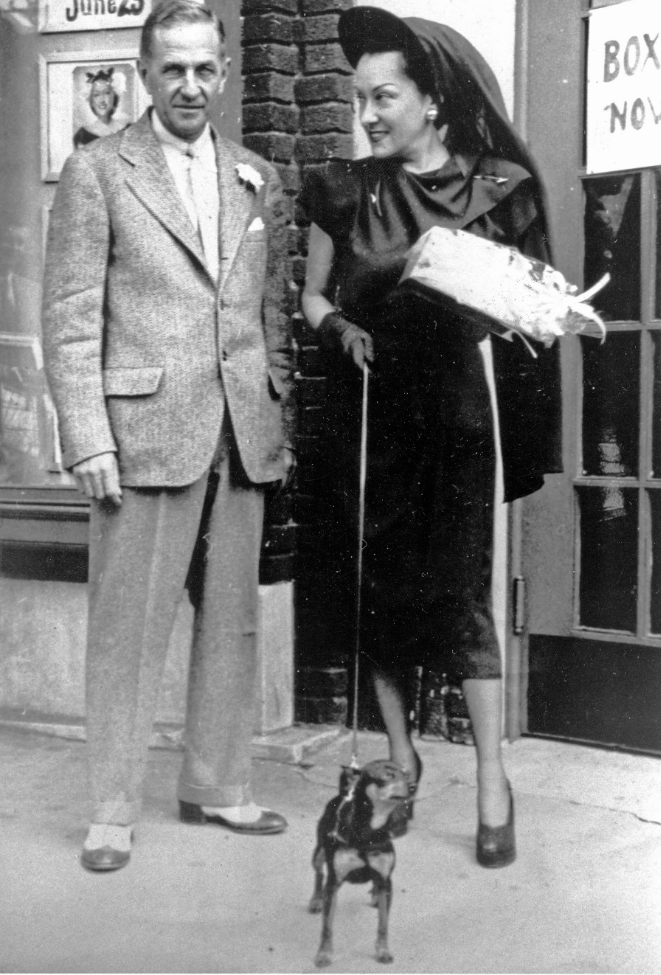 Beacon mayor J. Lewis Bolton officially welcomes Gloria Swanson to Beacon with orchids as they stand in front of the Roosevelt Theater in 1947