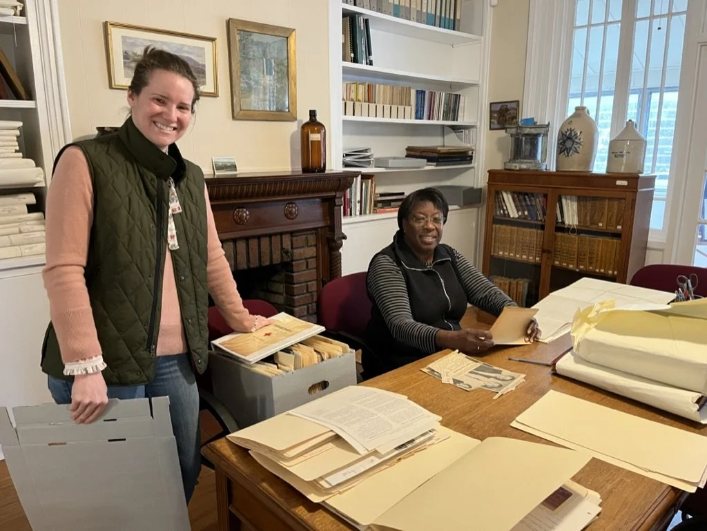 Volunteers in library organizing collection.jpeg