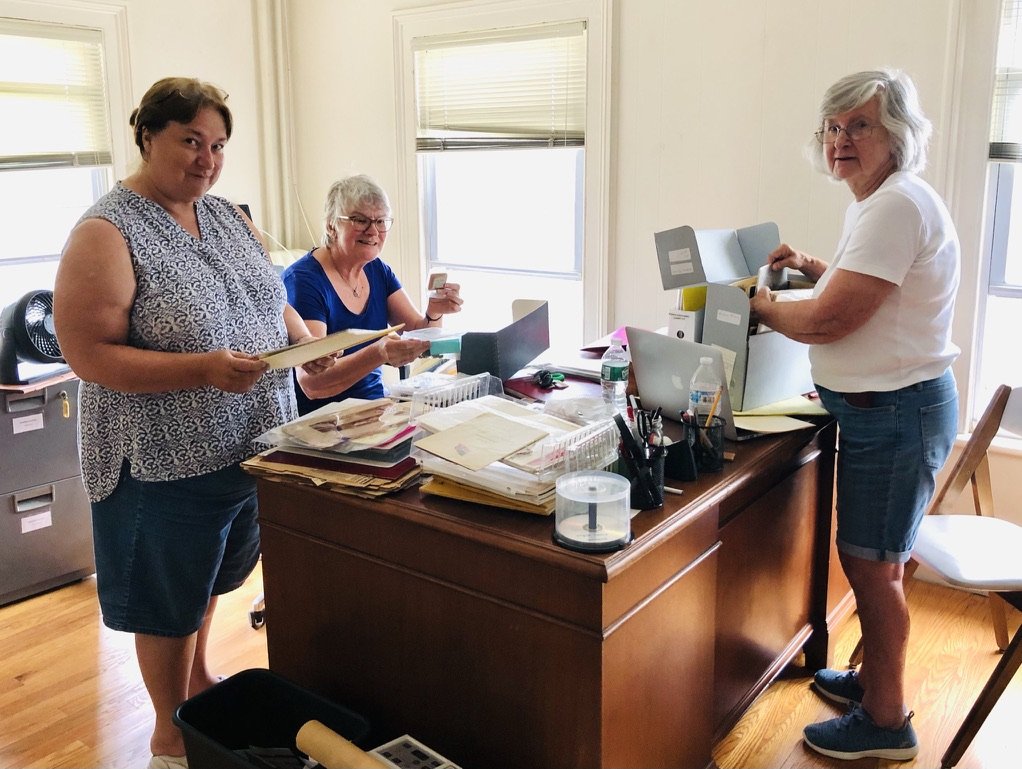 Volunteers organizing archive room.jpeg