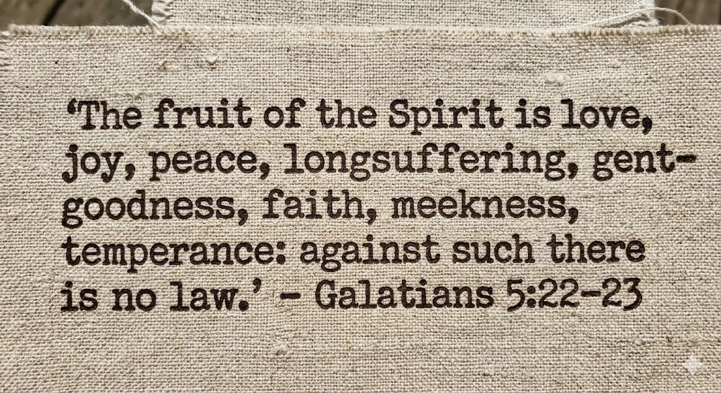Embroidery of a biblical quote from Galatians 5:22-23 about the fruit of the Spirit, including love, joy, peace, longsuffering, gentleness, faith, meekness, and temperance.