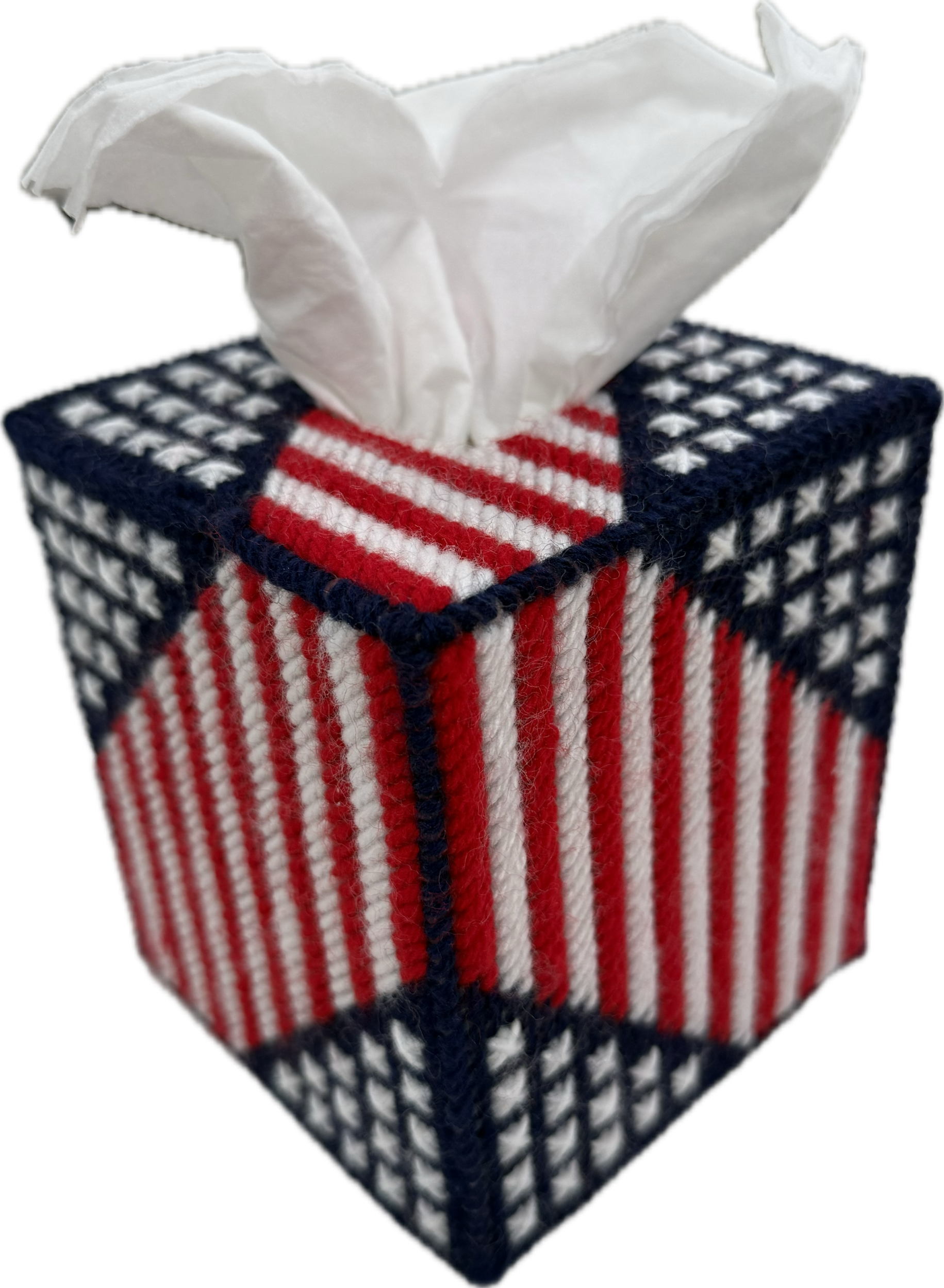 A tissue box with an American flag pattern, featuring red, white, and blue colors with stars and stripes, and a tissue protruding from the top.