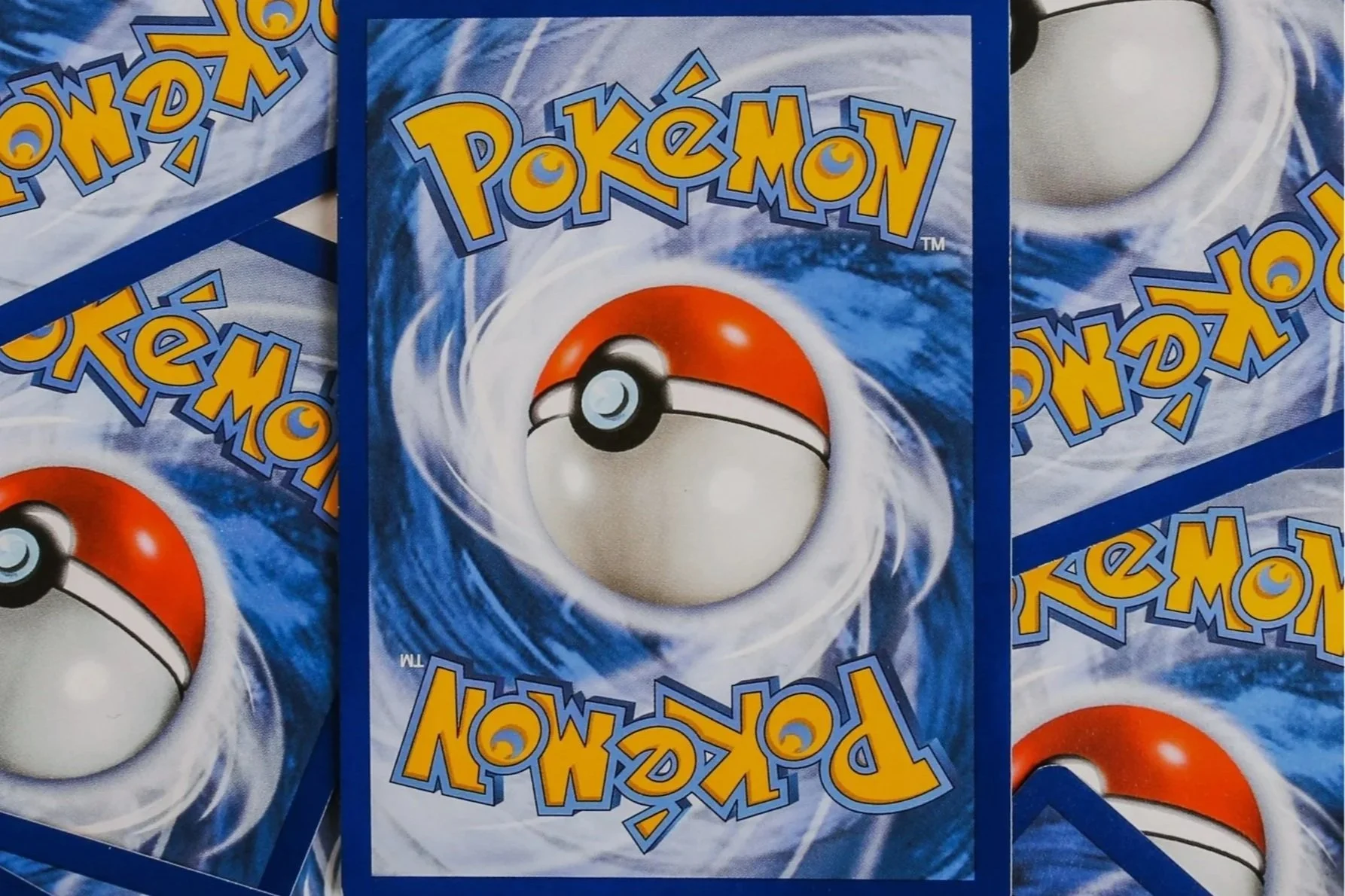Close-up of Pokémon trading cards featuring a Pokéball design on the back.