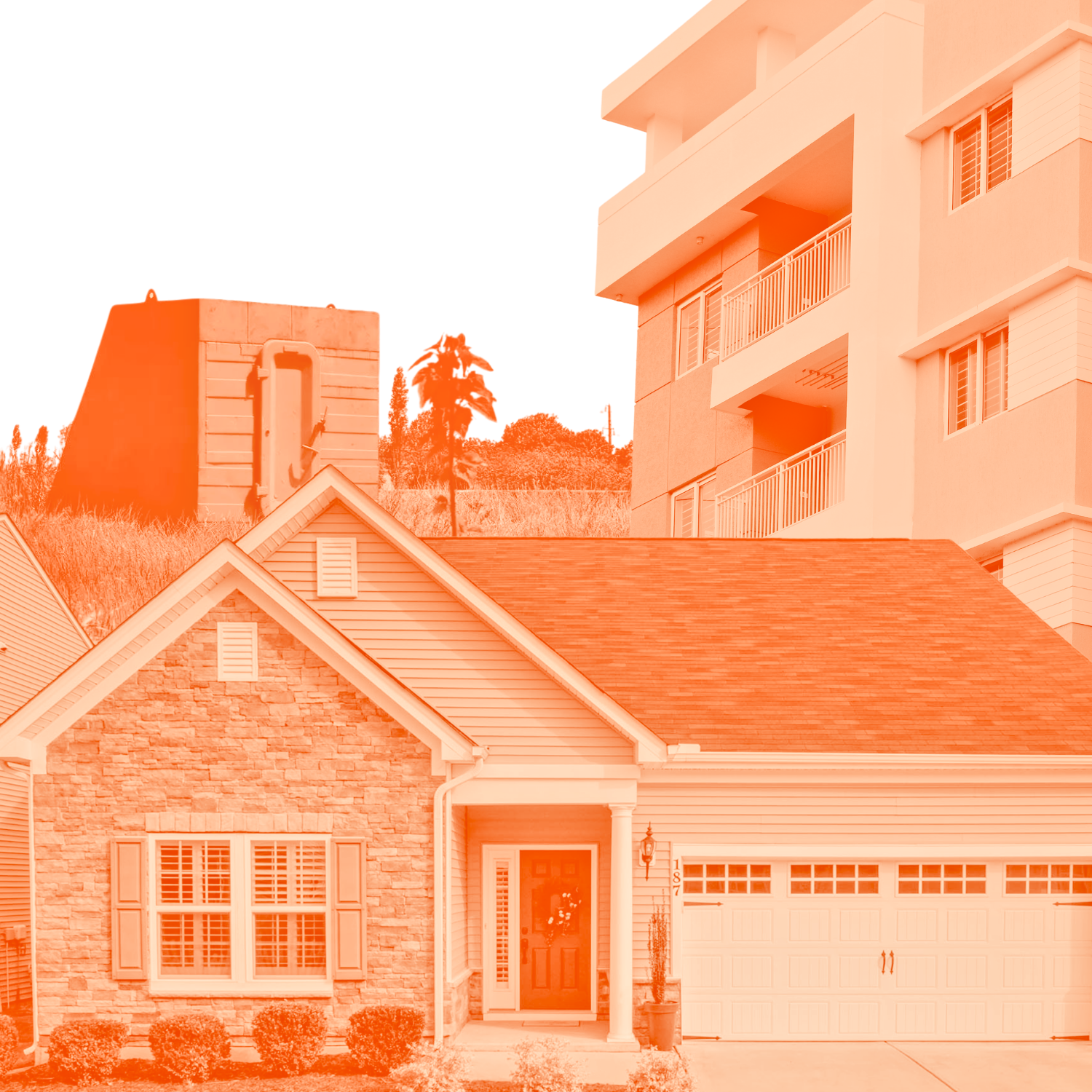 A residential neighborhood with a two-story house featuring a stone facade, front porch, and a white garage door. In the background, there are taller apartment buildings and a hill with trees and utility poles.