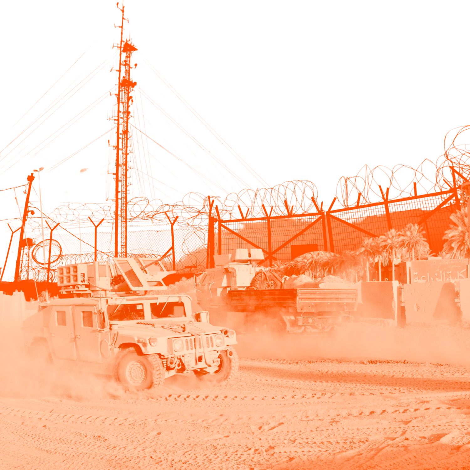 Military vehicle in desert with barbed wire fence, large grey barrier, and a tall transmission tower.