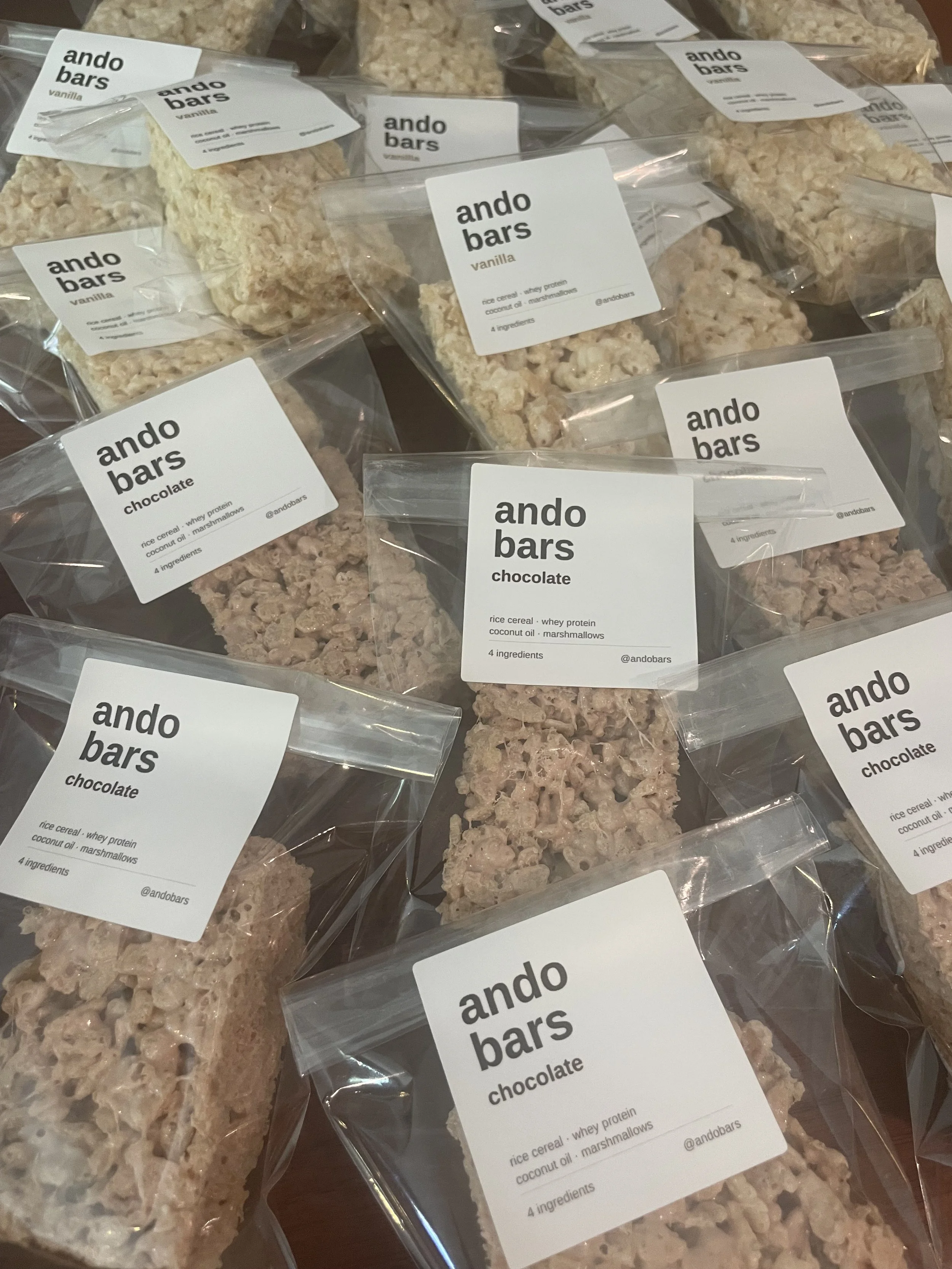 Several packages of Ando Bars in vanilla, chocolate, and cinnamon flavors ready to go.