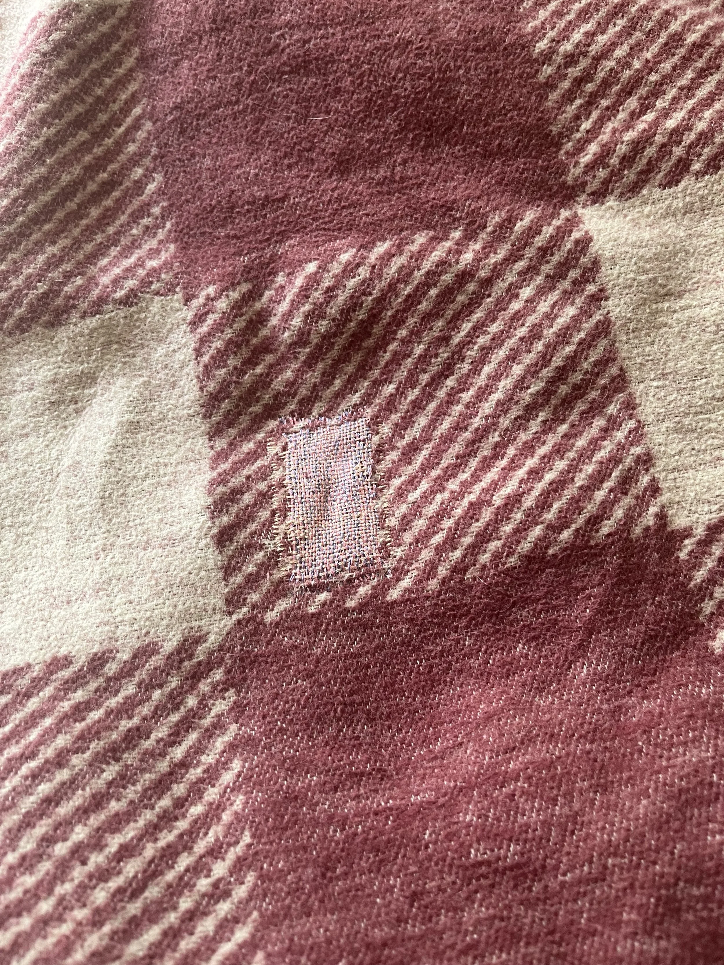 Patched hole in cotton blanket