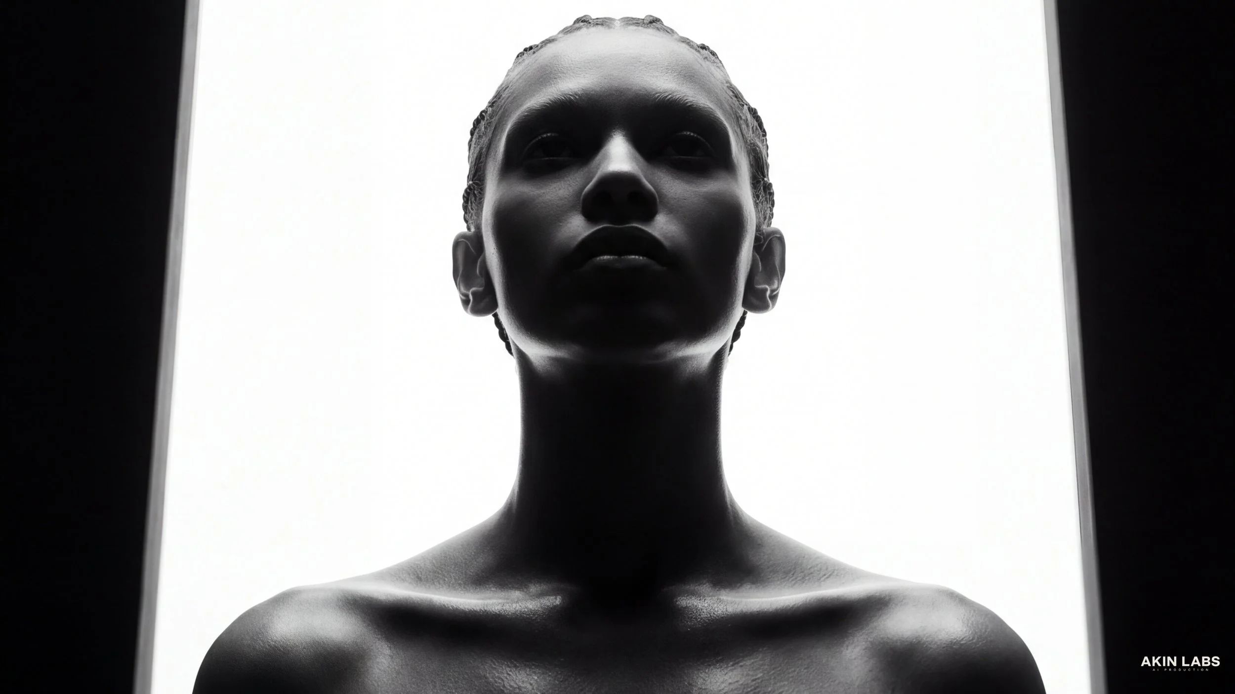 Black and white photo of a woman's face and shoulders, with her head slightly tilted up, framed by rectangular borders, with the text 'AKIN LABS' in the bottom right corner. Higgsfield, NanoBanana 2, Kling, LLM, Gemini. AI Cinema. AI Film.