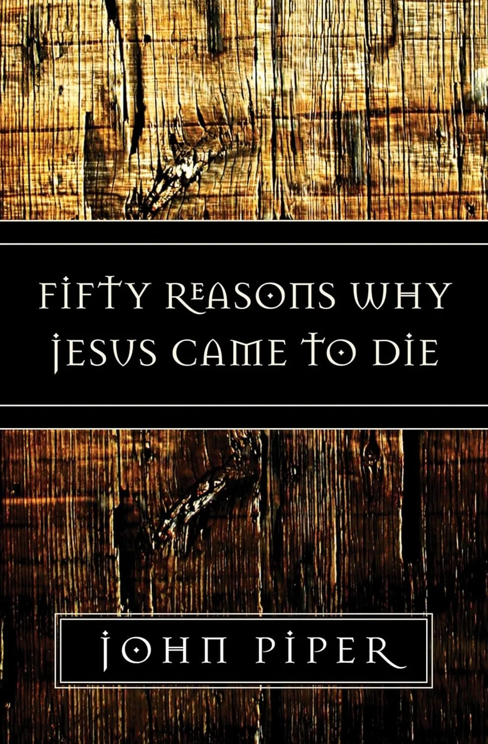 Book cover with a wooden background and black central panel. Title: "Fifty Reasons Why Jesus Came to Die" and author: "John Piper".
