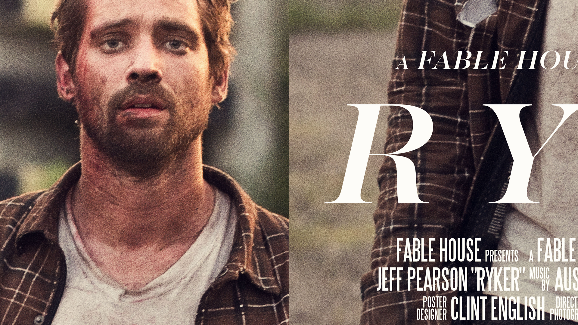 Close-up of a man with light skin and curly hair, wearing a plaid shirt over a white T-shirt, standing outdoors.