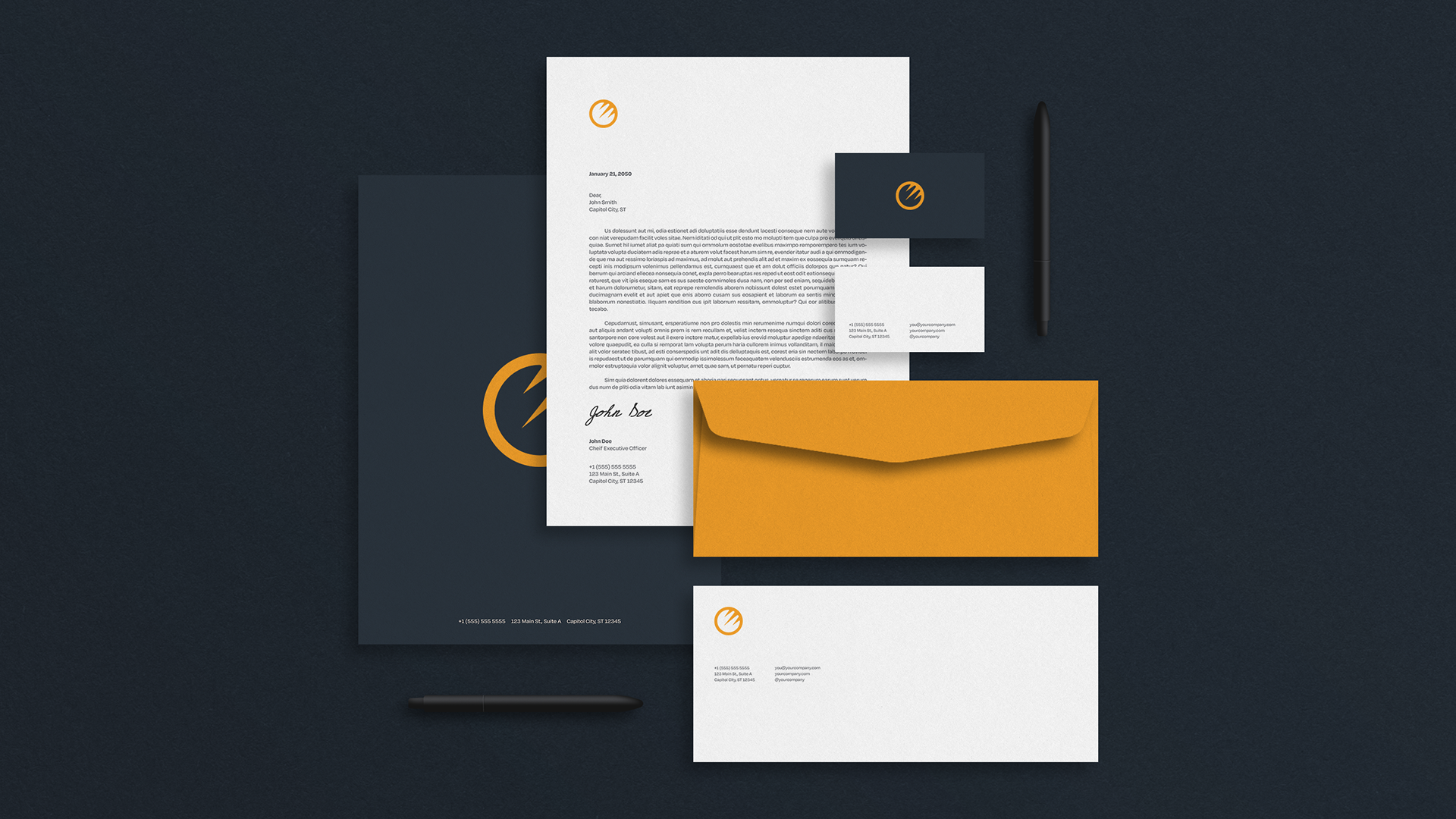 A dark background displaying corporate stationery including letterhead, business card, envelope, and a pen, with a yellow and navy color scheme.