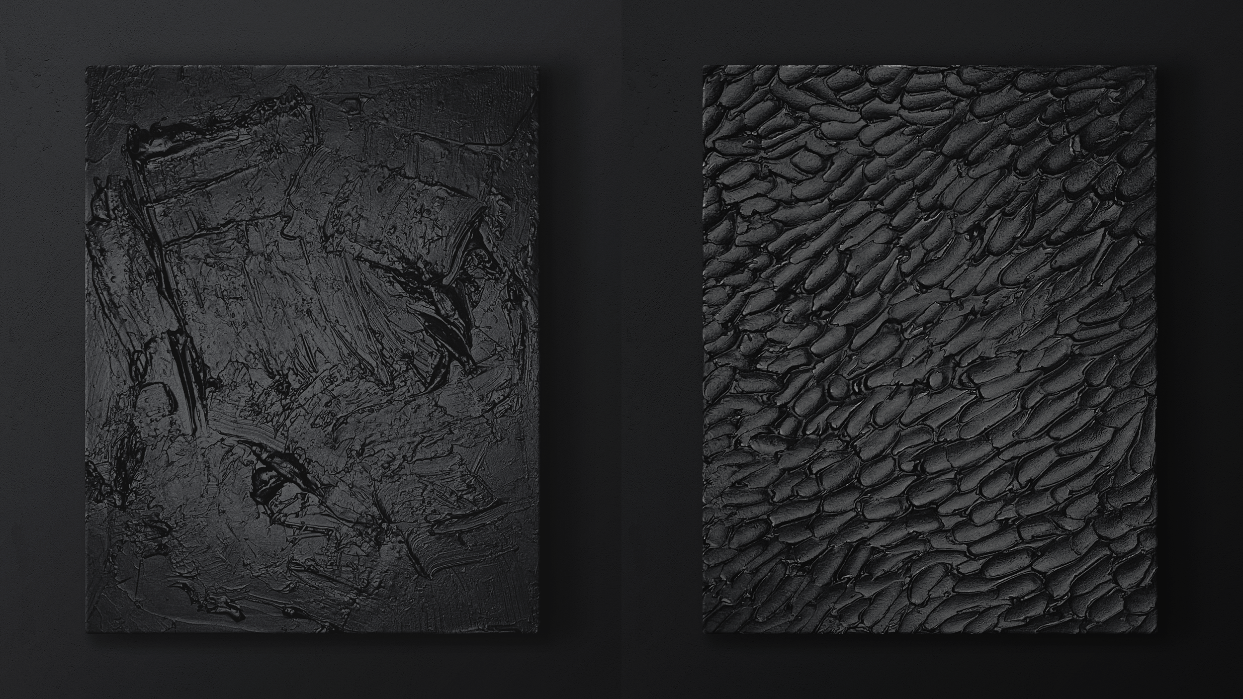 Two black textured tiles, one with a rough, irregular pattern, and the other with a pattern resembling small, overlapping scales, mounted on a dark wall.