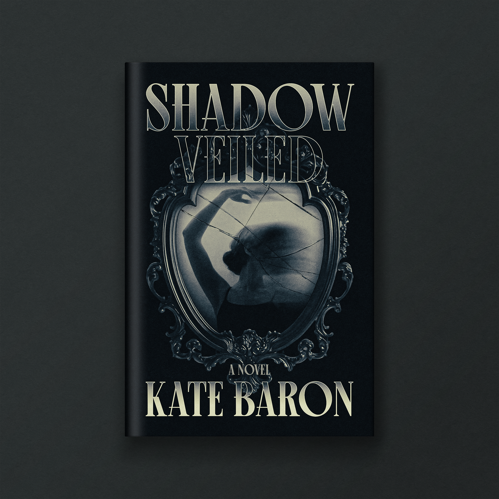 Cover of the novel titled 'Shadow Immobilized' by Kate Baron, featuring a silver ornate mirror frame with a black and white portrait of a woman and a broken glass in the center.