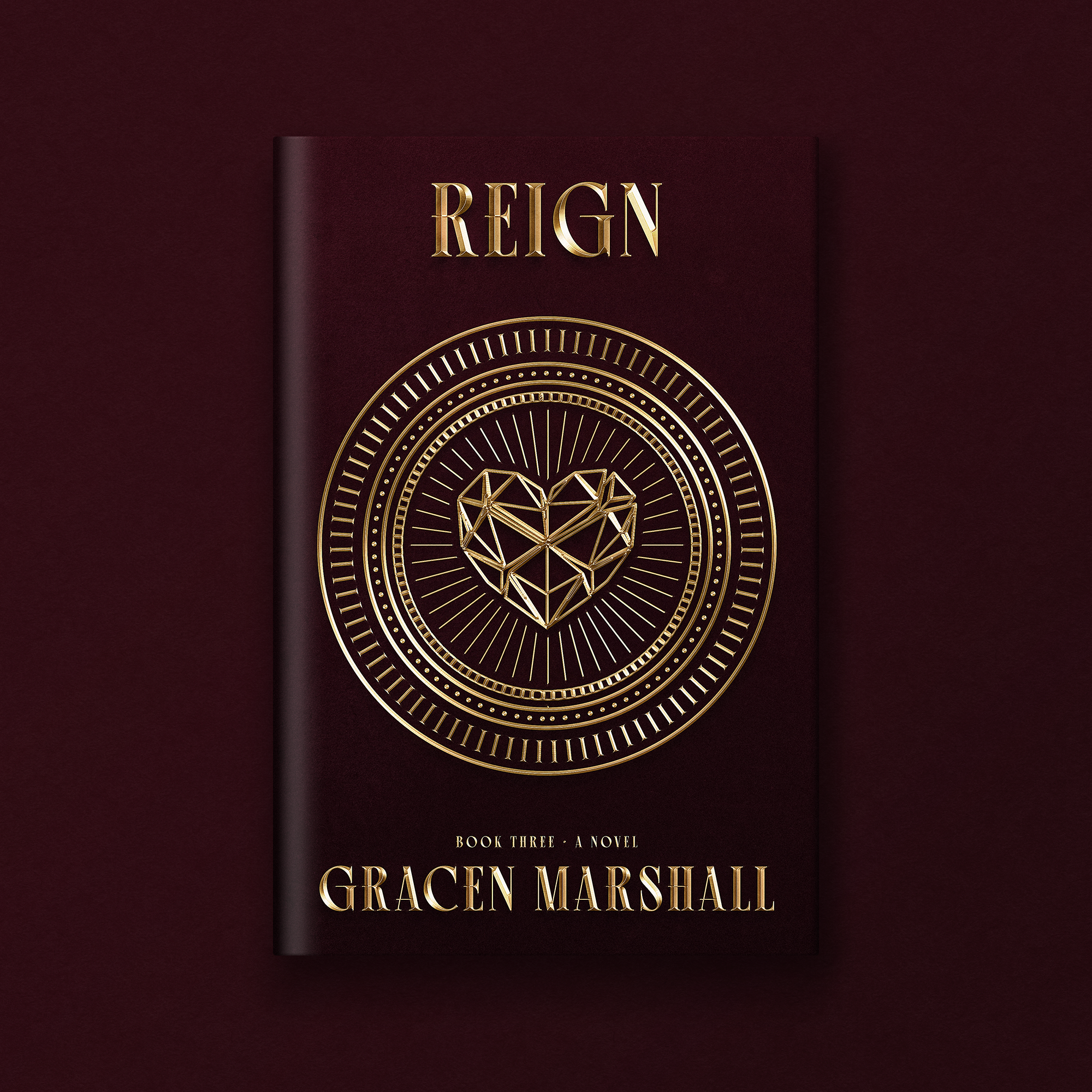 Cover of a book titled "Reign" by Gracen Marshall, featuring a geometric heart design with gold accents on a dark maroon background.
