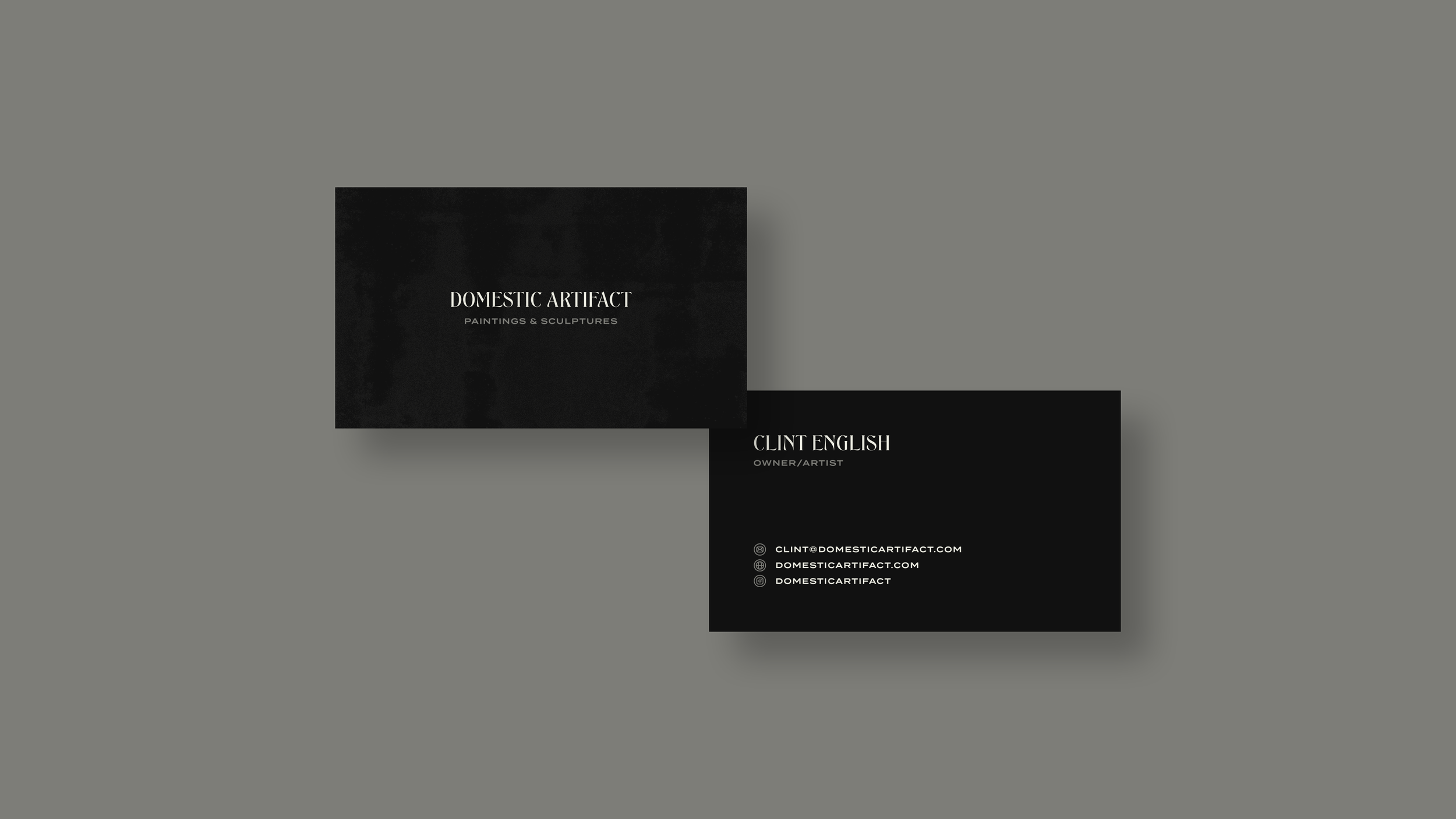 Business cards for Domestic Artifact featuring black backgrounds, white text, and contact information for Clint English, owner and artist.