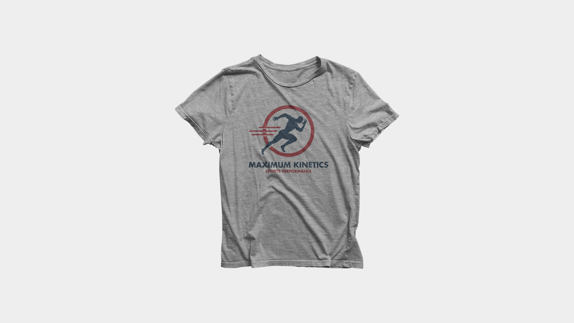 Gray T-shirt with a running figure logo and text 'MAXIMUM KINETICS' and 'SPORTS PERFORMANCE' printed on it, lying flat on a white background.