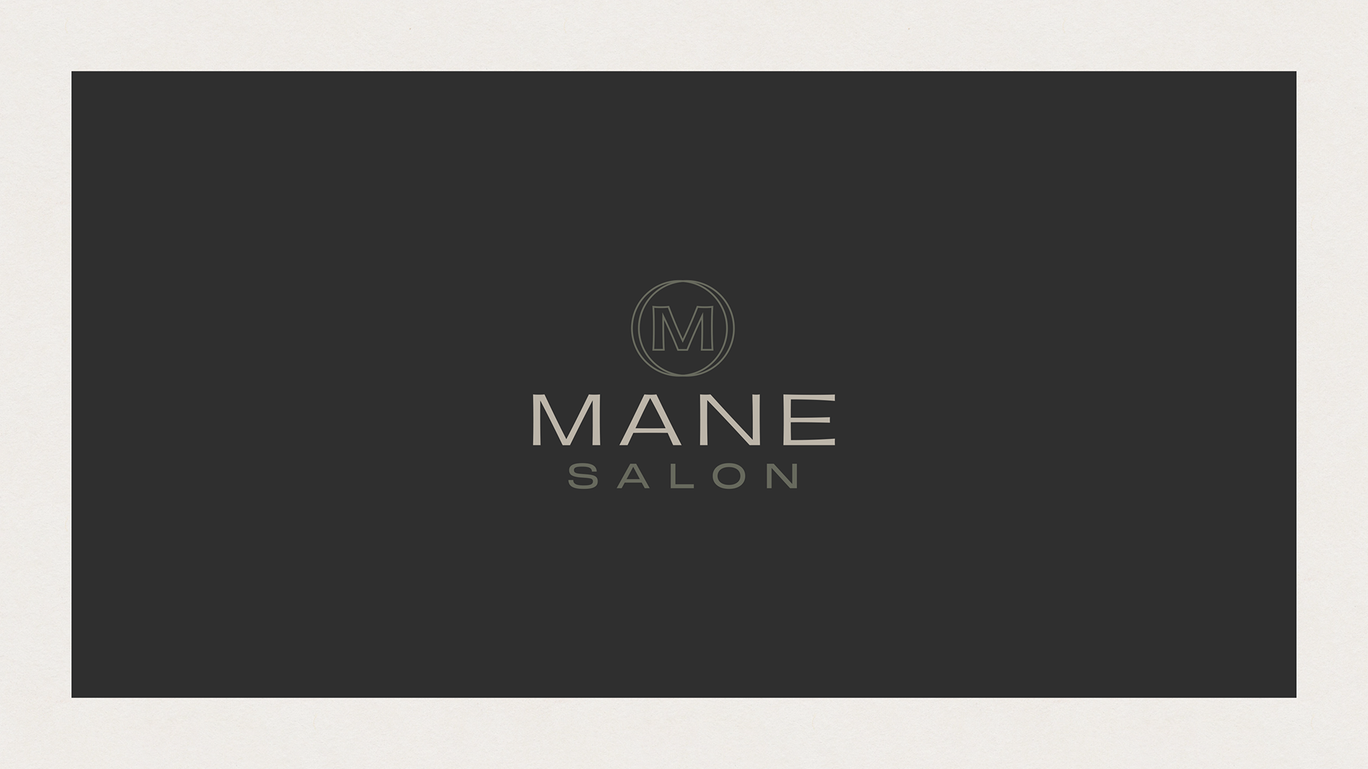 Black card with silver text and logo for Mane Salon, featuring a stylized 'M' within a circle.