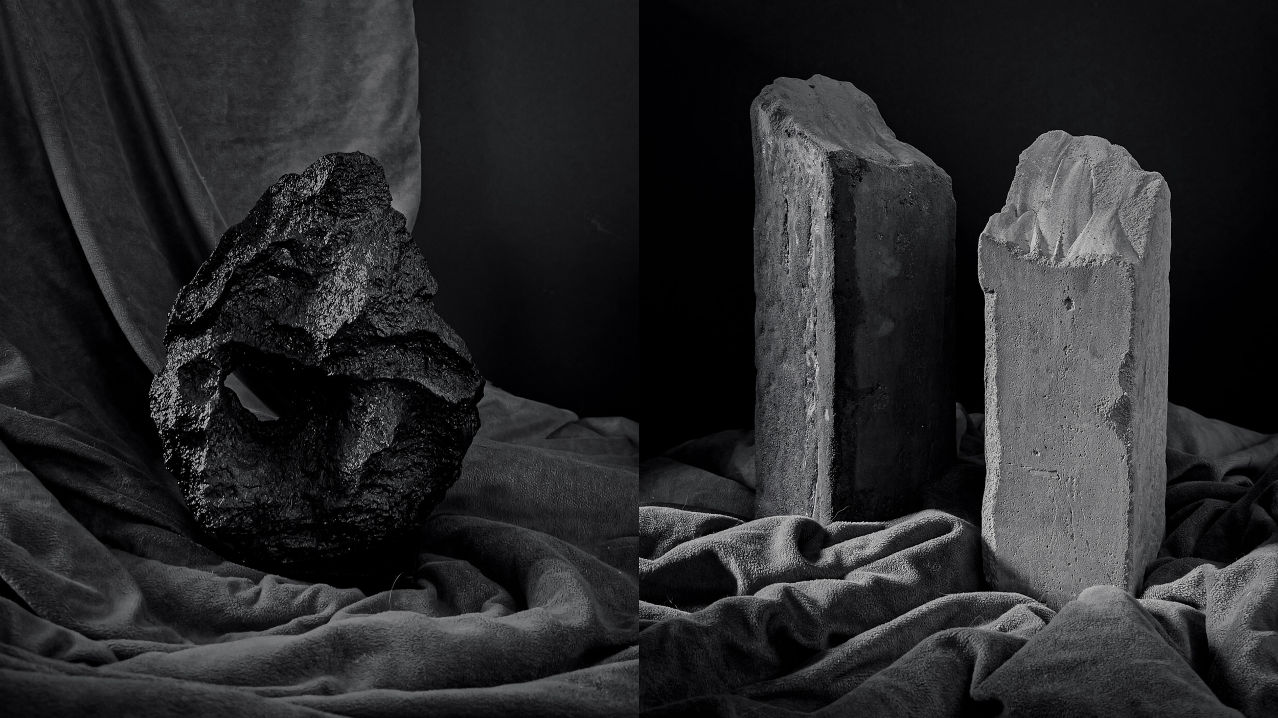 Three vertically standing stone sculptures with different textures and forms, set against a dark background, on a soft, textured fabric surface.