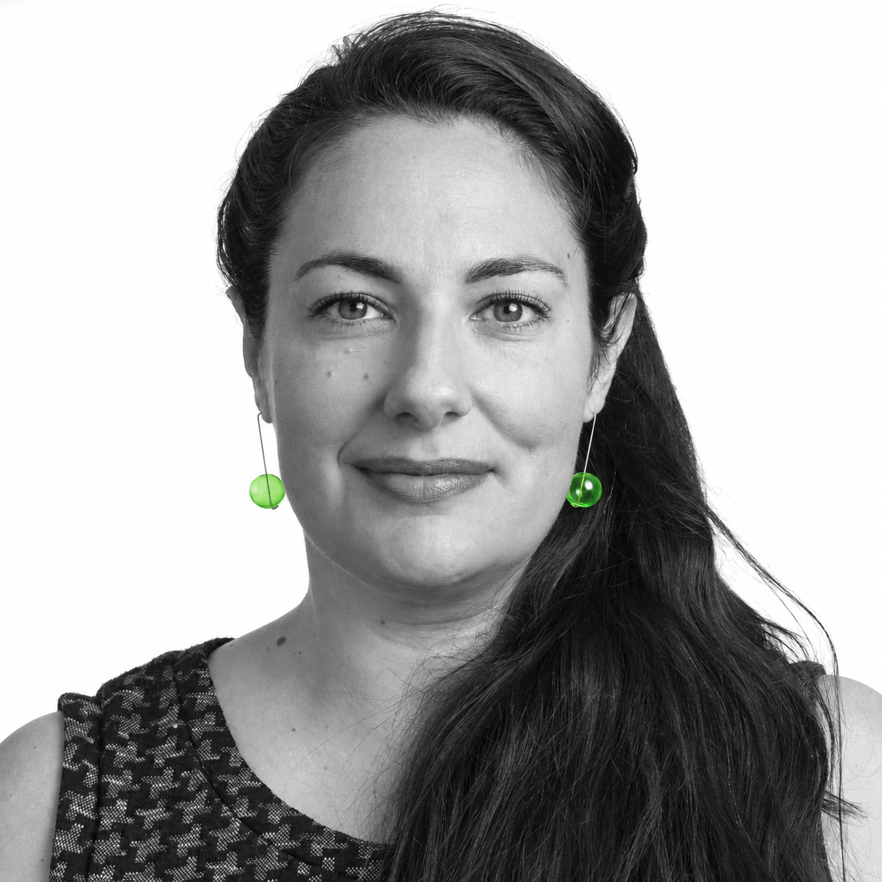 Rachel Wilkins, founder of LOCUS, in a black-and-white portrait with green glass earrings