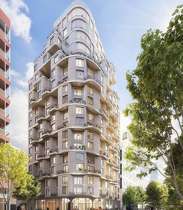 Modern multi-story residential building with rounded balconies, large windows, and surrounding green trees in an urban setting.