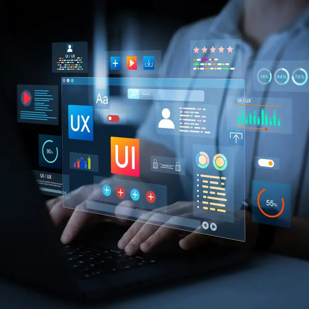Person using a laptop with transparent digital interfaces showing UX and UI design elements, charts, and statistics.