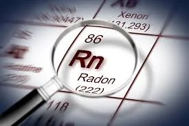 Magnifying glass positioned over the element Radon (Rn) from the periodic table.