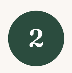 Dark green circular sign with white number 2 in the center.