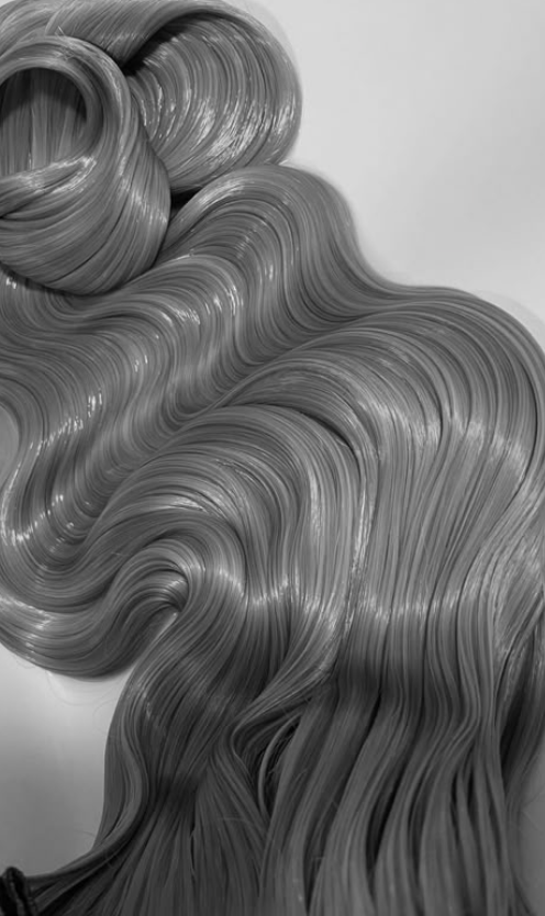 Close-up of long, wavy, shiny gray hair strands.