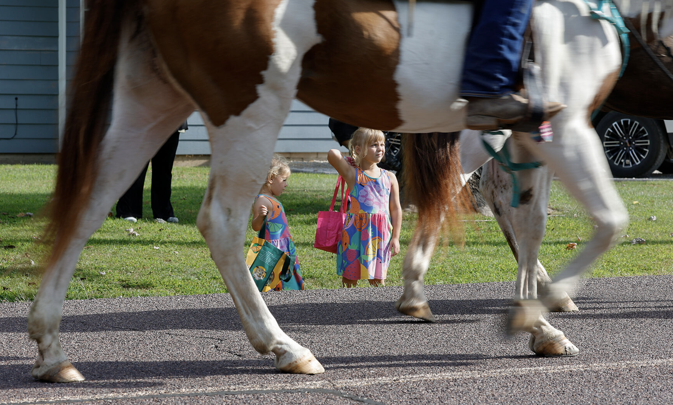 Lawson Martin, 4, left, and Grace Powler, 5, watch the Cattlemen Days Rodeo parade on Aug. 29 on Broadway in Ashland, Mo. After the parade, families were welcome to go to Kiddy Round Up for more rodeo experiences.
