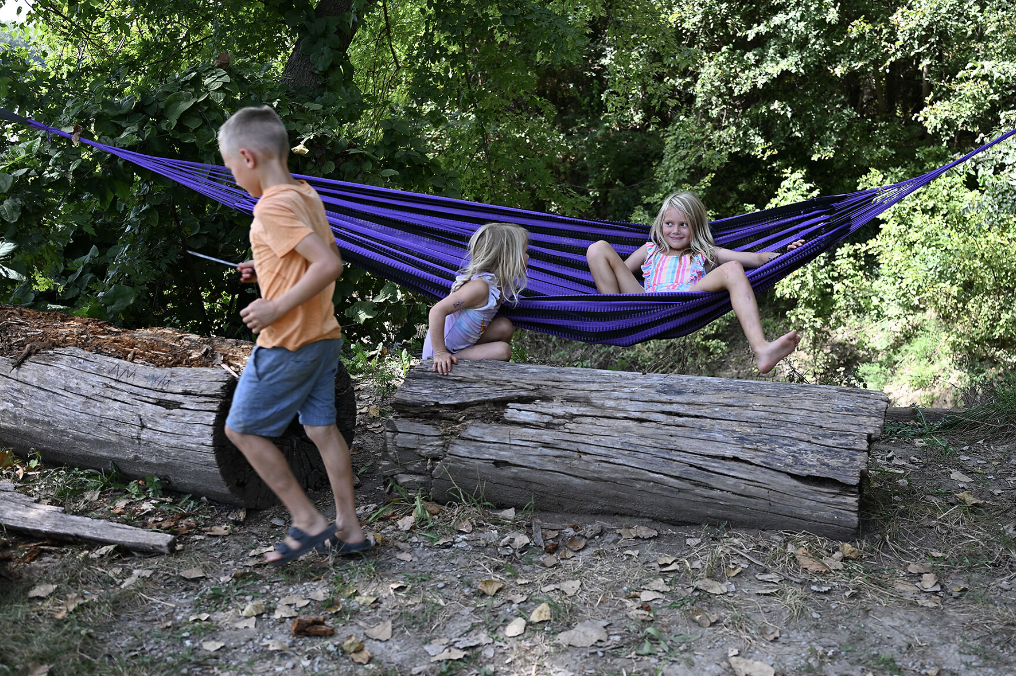 Ella Grunenwald, 9, right, swings in the hammock while playing with her siblings Cora Grunenwald, 4, center, and Cade Grunenwald, 7, left, during a Labor Day celebration on Monday at Cooper’s Landing.
