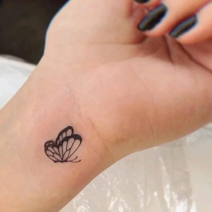Dainty butterfly fine line tattoo in Ohio