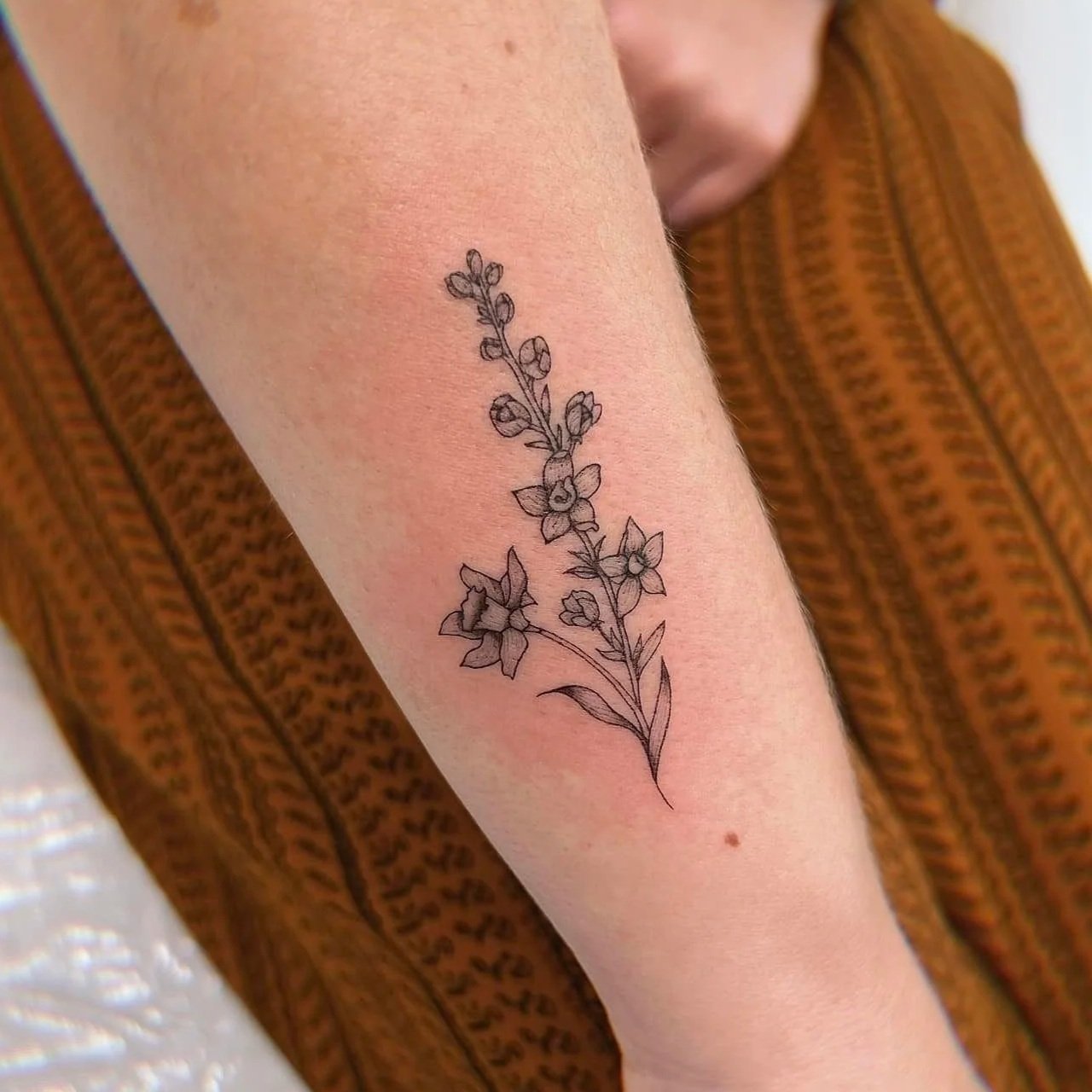 Sword and floral fine line tattoos in Ohio