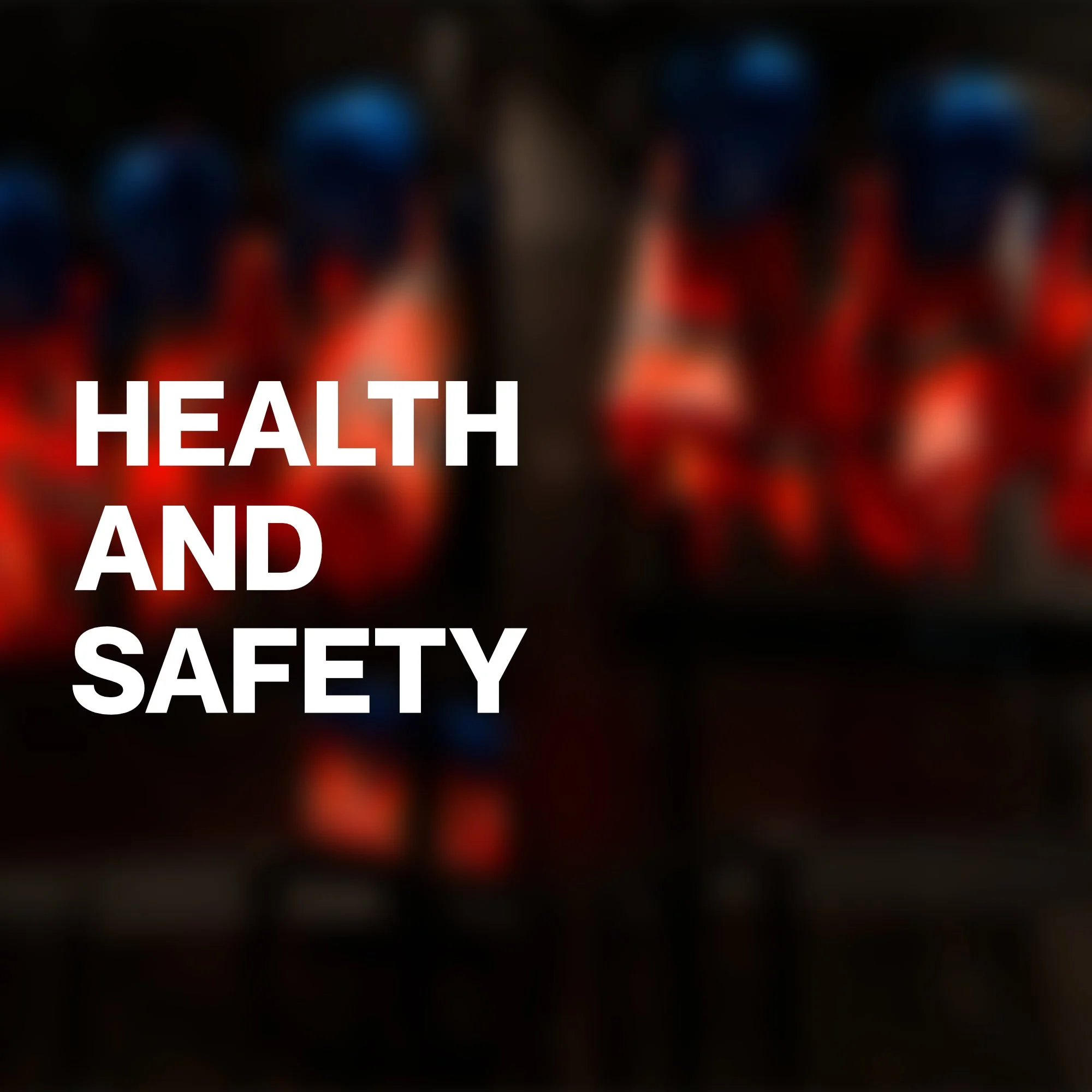 Blurred background with red, blue, and black colors and white text reading 'Health and Safety'.