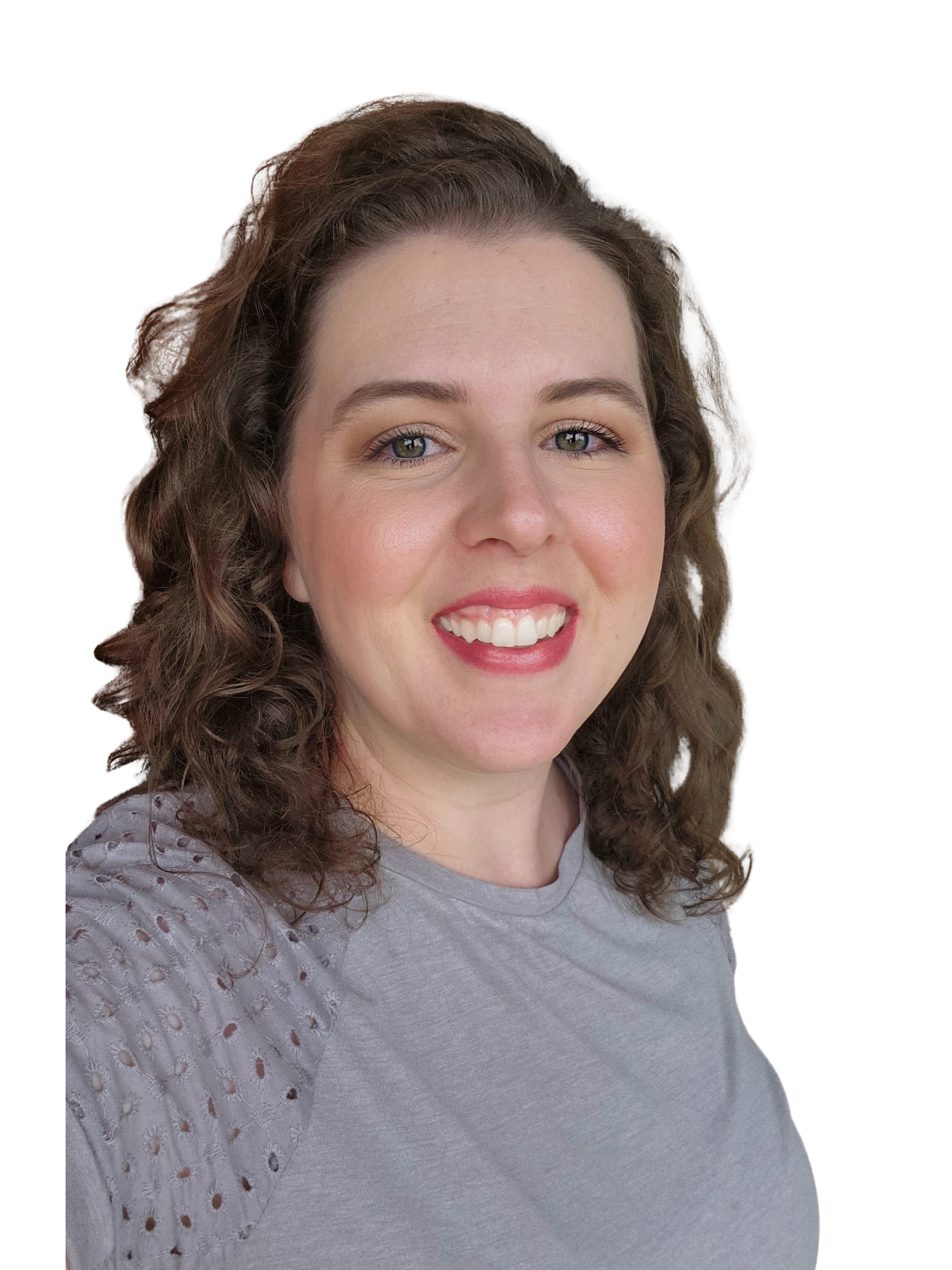 Close-up of a smiling woman with curly brown hair, wearing a light grey top with eyelet details on the sleeves, against a black background.