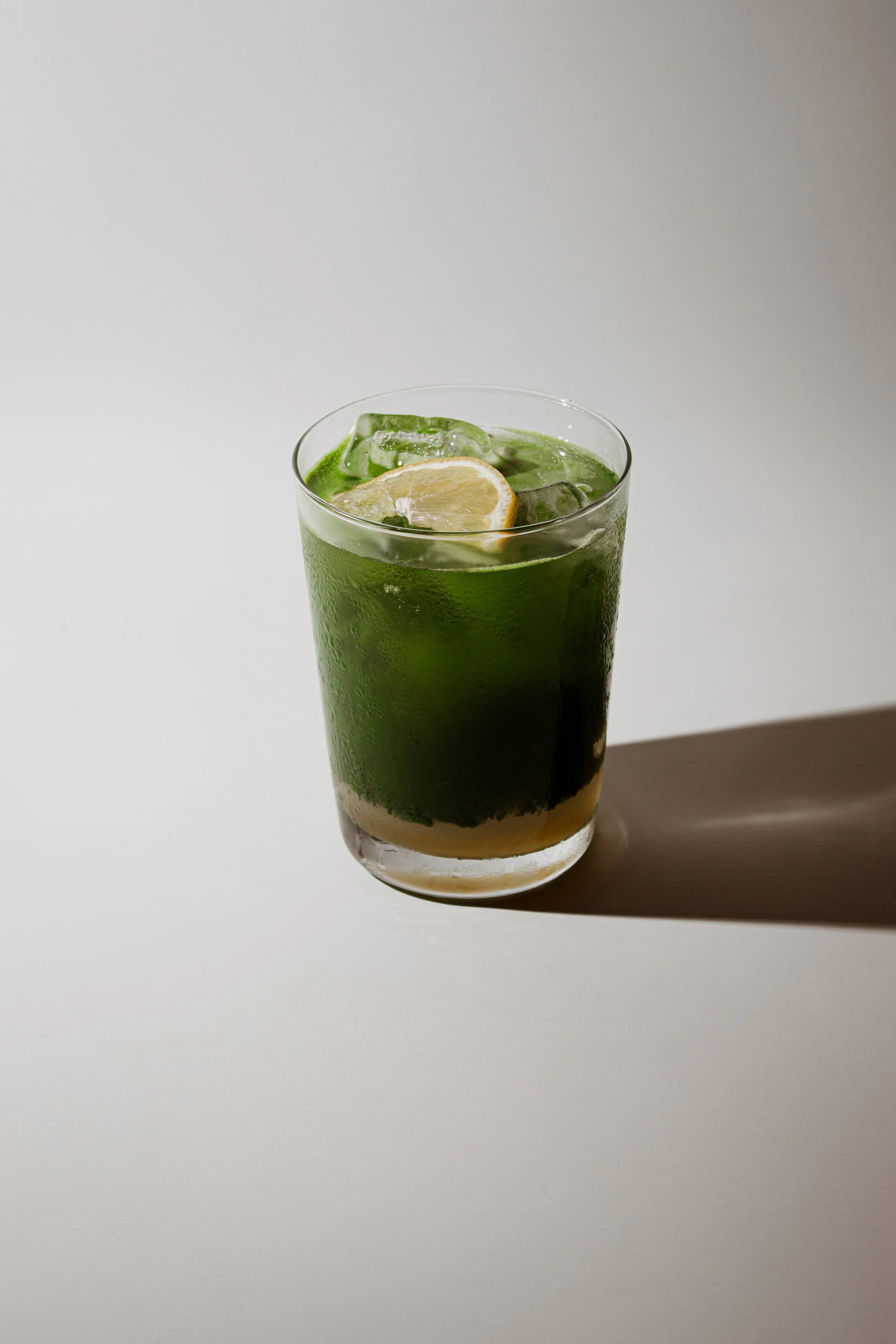 Refreshing Matcha Spritz made with ceremonial matcha, lemon oleo saccharum, fresh lime juice, and sparkling water at REMU Tulum.