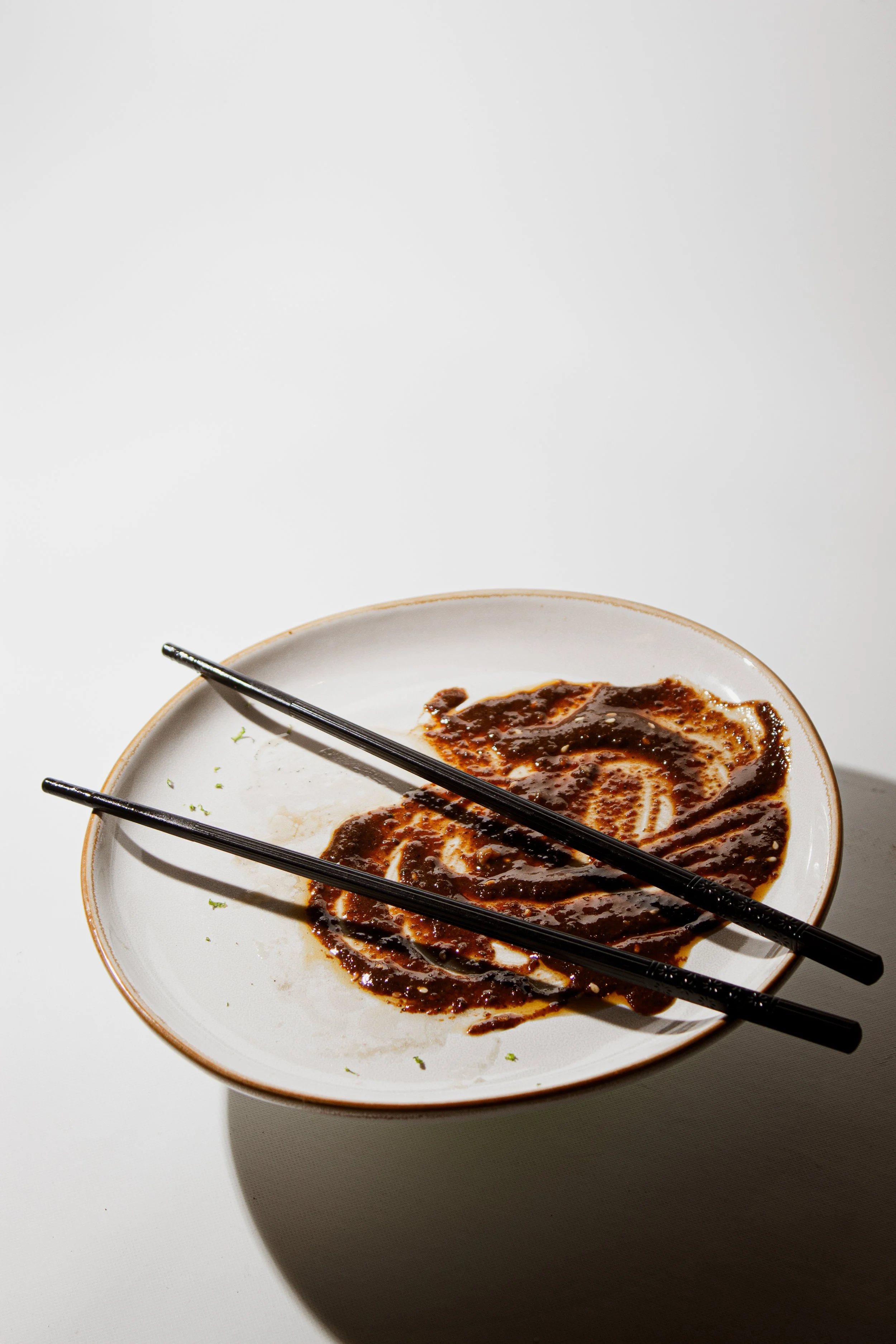 Japanese mole sauce on a plate after enjoying REMU Tulum’s signature chutoro dish.
