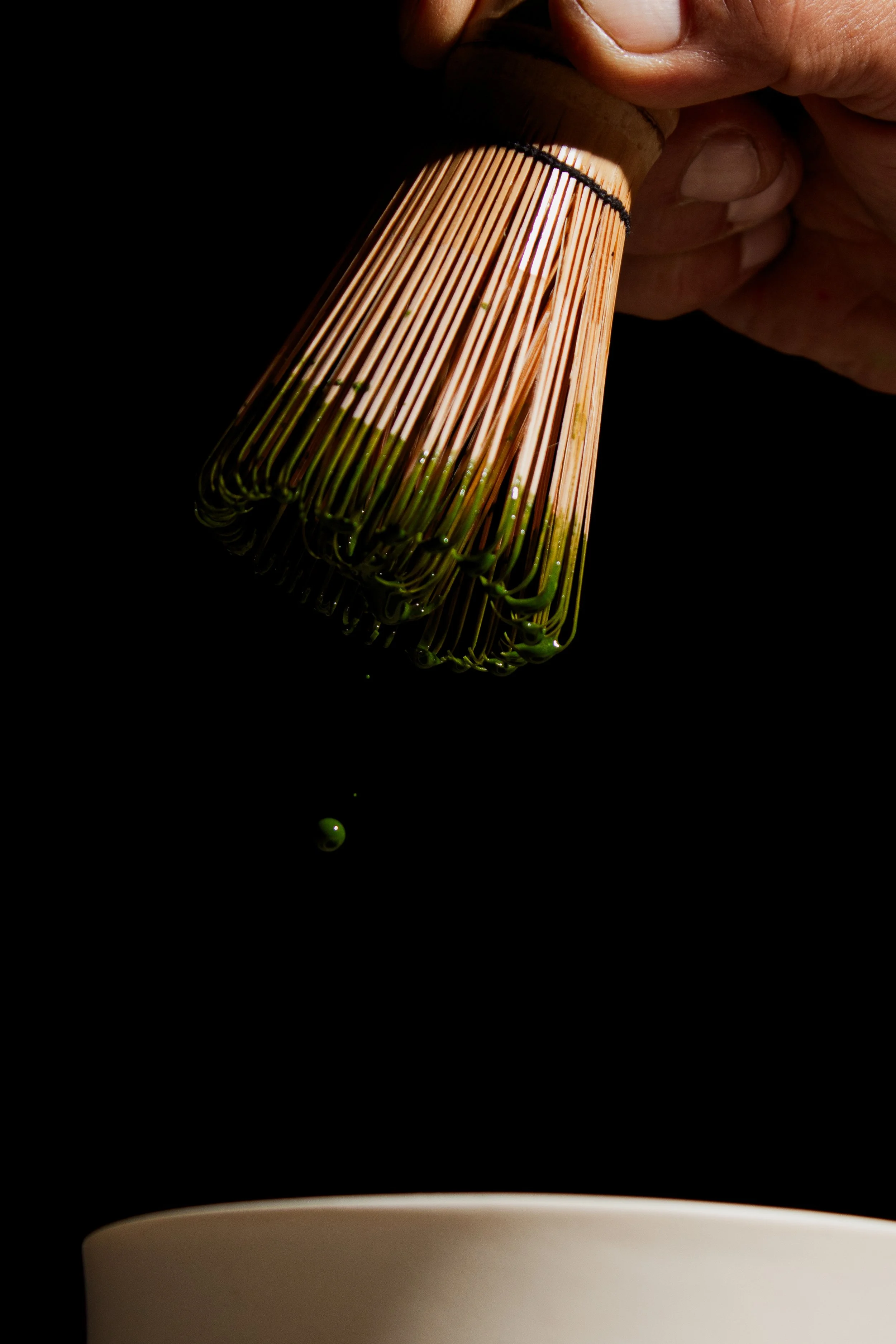 Traditional bamboo whisk preparing ceremonial grade matcha at REMU matcha and sushi bar in Tulum.