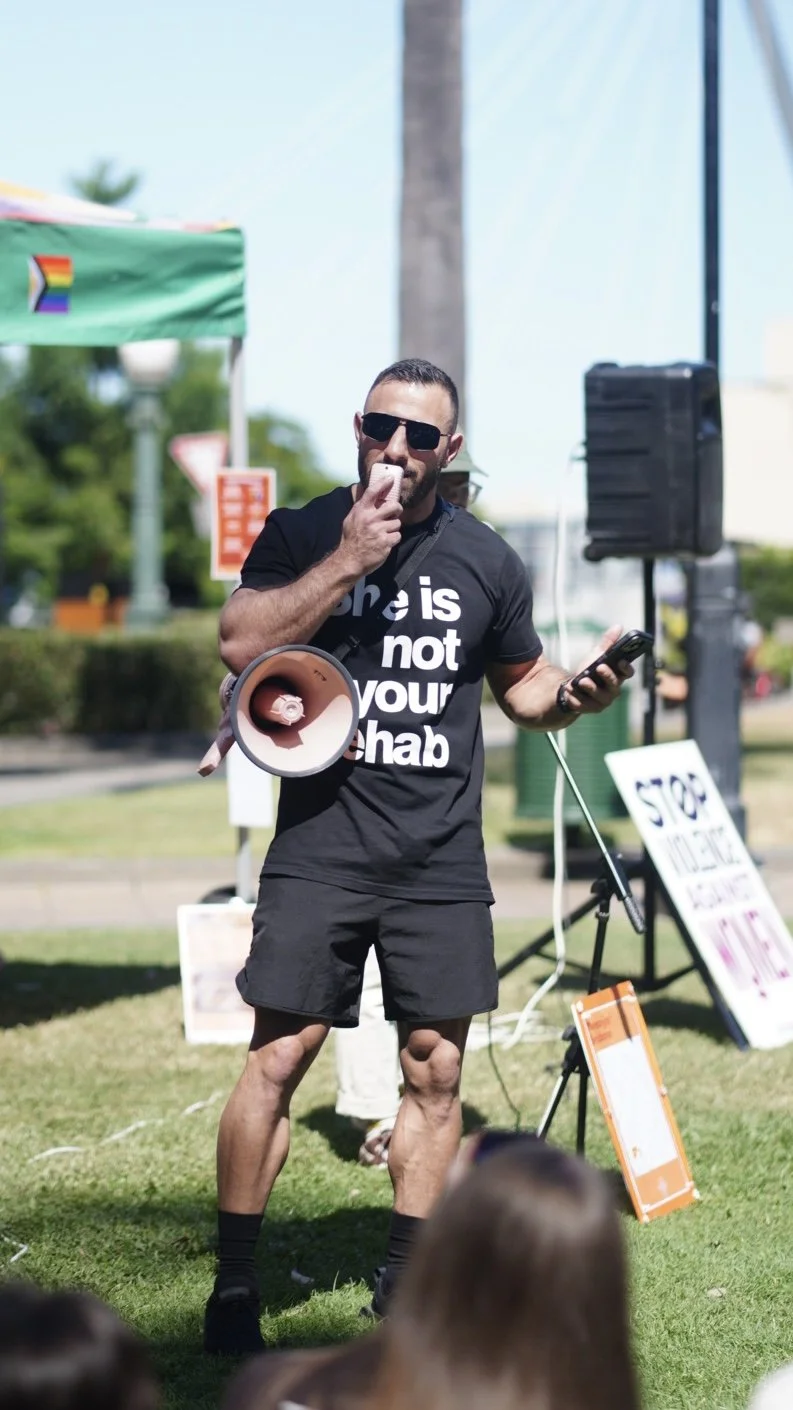 Dave Kramer speaking at a What Were You Wearing rally.