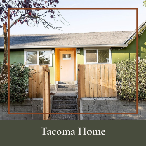 Front view of a green house with a wooden fence, stone steps, and a white front door, labeled 'Tacoma Home'.