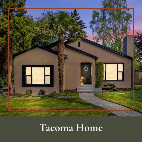 Front view of a suburban house with a palm tree, two large windows with black frames, a welcoming front door, and a well-manicured lawn at sunset.