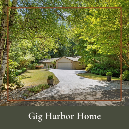 A house with a driveway surrounded by lush green trees and landscaping, labeled 'Gig Harbor Home'.