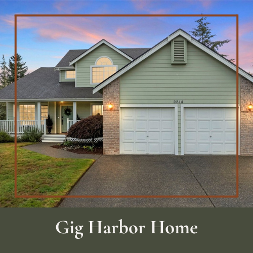 Front view of a two-story house with a double garage, green siding, brick accents, and a manicured lawn during dusk.