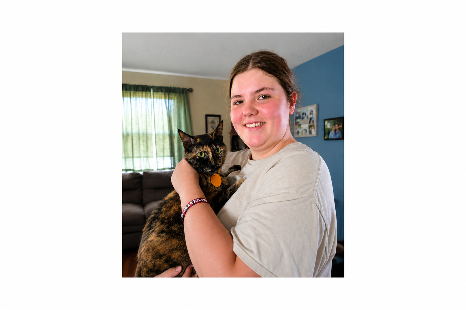 teen girl holding a tortoiseshell cat